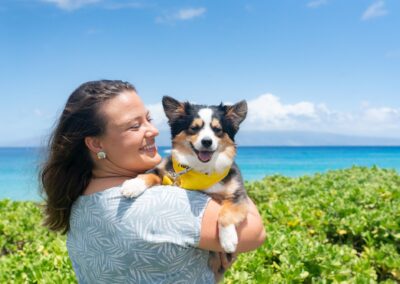 Wags to Riches promo at Royal Lahaina Resort - Lady holding cute dog in front of beach